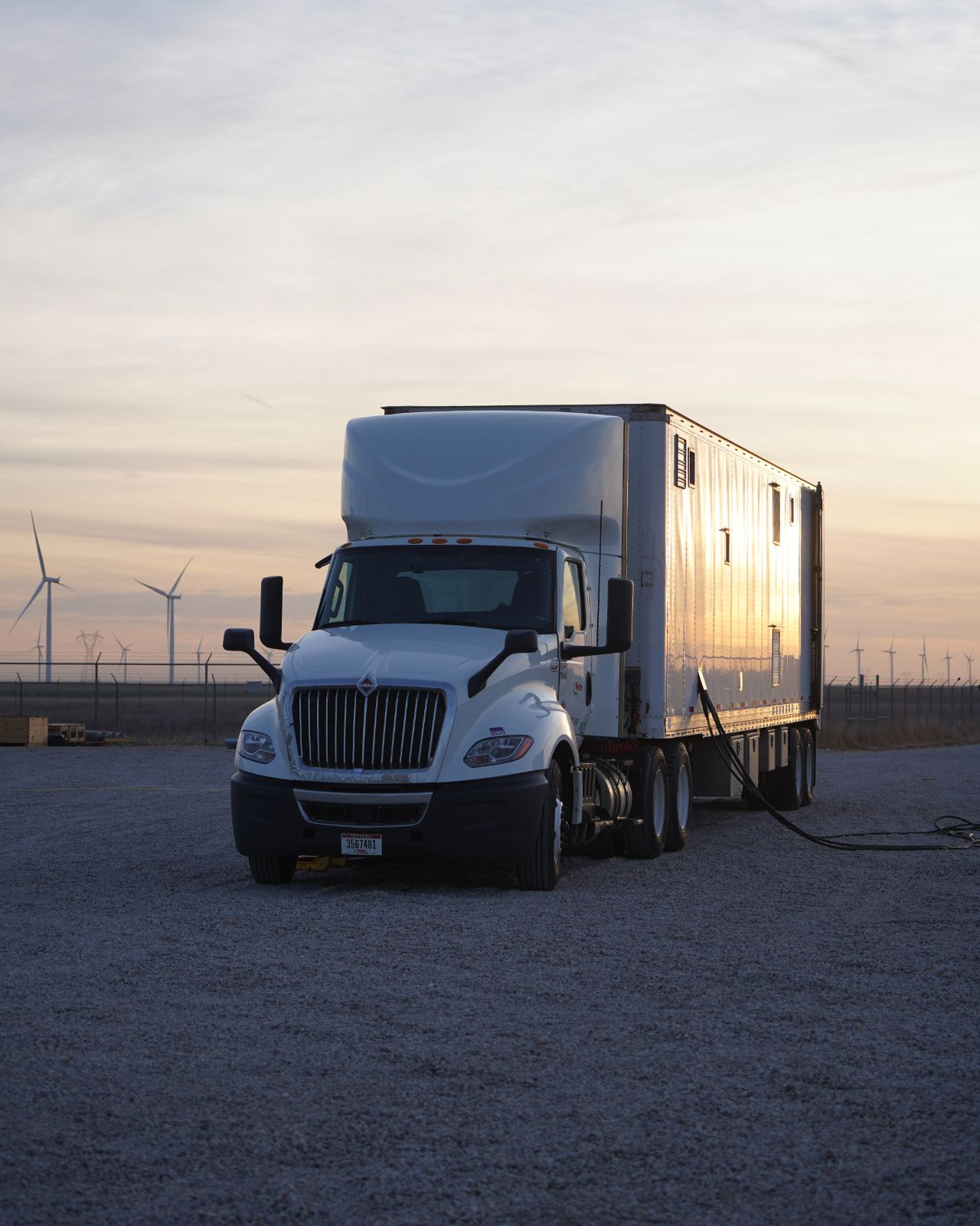 A JCL test trailer rolling out at dawn
